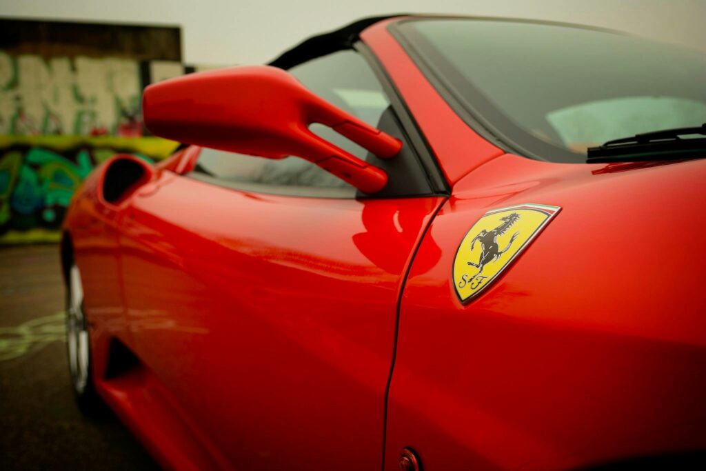 Close-up of a red luxury sports car showcasing sleek design in Den Helder, Netherlands.